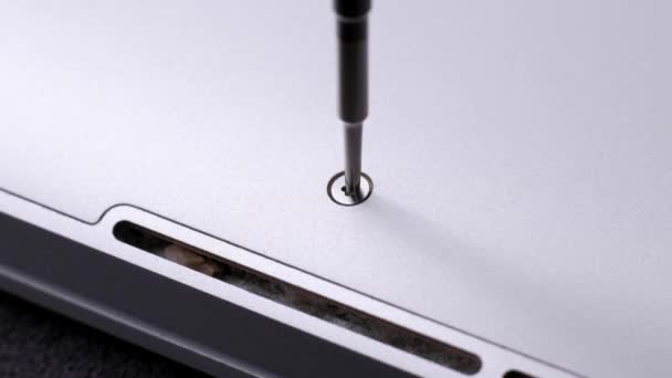 Master unscrewing small screw with magnetic screwdriver tool of broken laptop. — Stock Video