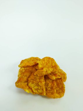 Temiz beyaz arkaplanda ayarlanmış kızarmış tempeh çiplerinin yakın plan görüntüsü.