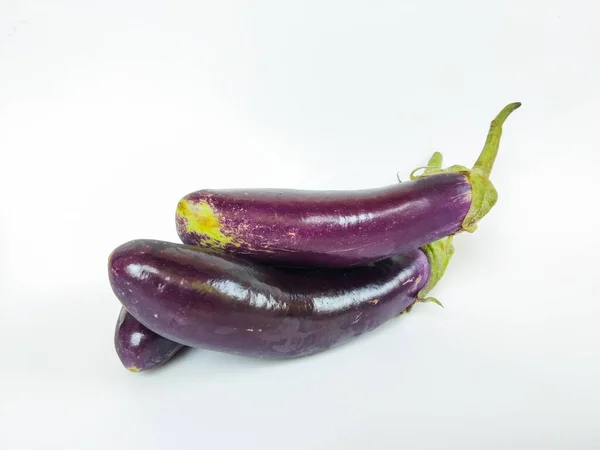 A close-up image of fresh purple eggplants arranged on a clean white background