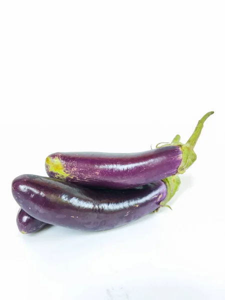 A close-up image of fresh purple eggplants arranged on a clean white background