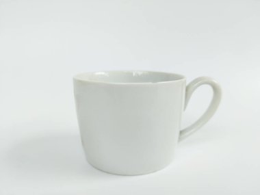 Boş beyaz bir seramik kupanın minimalist bir stüdyo fotoğrafı temiz beyaz bir arka plana yerleştirilmiş..
