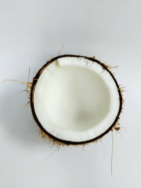 Temiz beyaz bir arkaplana yerleştirilmiş yarım hindistan cevizinin yakın plan çekimleri.