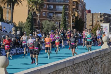 Bir grup koşucu, 2025 Valencia Maratonu 'nun bitiş çizgisine yaklaşıyor. Trinidad Alfonso Zürih. Valencia, İspanya - 7 Aralık 2025.
