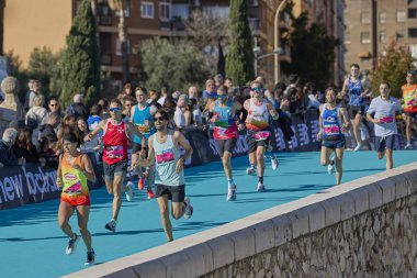Bir grup koşucu, 2025 Valencia Maratonu 'nun bitiş çizgisine yaklaşıyor. Trinidad Alfonso Zürih. Valencia, İspanya - 7 Aralık 2025.