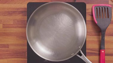 Elektrikli ocağın tavasına yerleştirilmiş çiğ tavuk köftelerinin üst görüntüsü