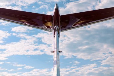 Orta boy özel bir jetin kuyruğu. Dikey ve yatay dengeleyici çekim açık mavi ve bulut dolu bir gökyüzü oluşturur.