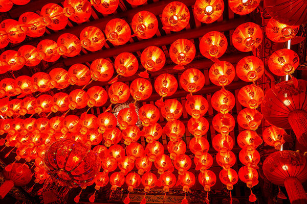 Many red lanterns are hung from the ceiling during the Chinese New Year festival in the shrine.