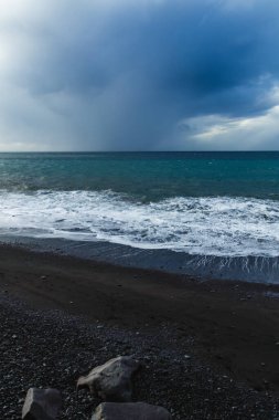 Kara Bulutlar, Yuvarlanan Dalgalar ve Huysuz Mavi Işıklı Madeira Okyanusu kıyısında dramatik bir fırtına..