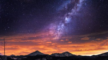 Gün batımında bir dağın üzerinde Samanyolu Galaksisi, masaüstü veya görsel proje için estetik evren arka planı