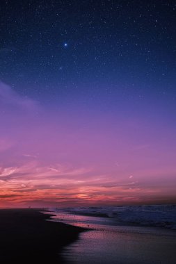Yıldızlı gece ve mor eğimli gökyüzü gün batımında bir nehir manzarası üzerinde, telefon arkaplanı için sakin bir sahne