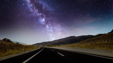 Samanyolu Galaksisi ve yıldızlı gökyüzü gece bir yol manzarası üzerinde, masaüstü duvar kâğıdı için 4k ortam arkaplanı