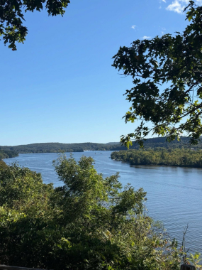 Breathtaking elevated view of a wide river on a sunny day.