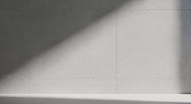 Düz bir duvar ve ince bir çıkıntı boyunca köşegen gölgesi olan tek renkli soyut sahne, katı geometrik bir kontrastı ve minimalist mimari bir ruh halini üretiyor..