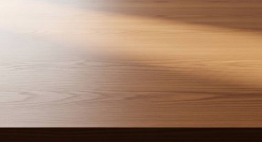 Close up shot of a wood desk surface highlighting natural grain and warm tones