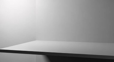 Düz bir masa yüzeyi ve üst soldan ince bir ışık içeren tek renkli bir sahne sakin bir minimalist çalışma alanı oluşturur.