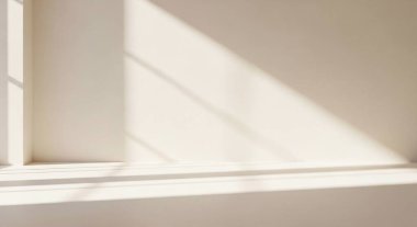 Soft sunlight creates geometric shadows across a white interior corner