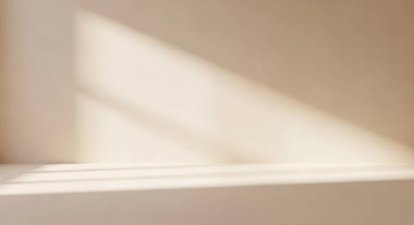 Soft warm sunlight streams through a window casting generous beams and long shadows across a clean interior floor, creating a calm minimal scene.