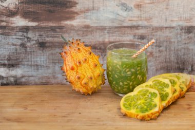 Köy tahtasında saman ve egzotik meyve dilimlenmiş karpuz suyu, canlı, ferahlatıcı tropikal hayat.