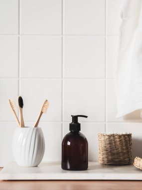 Banyoda banyo ürünleri, spa şampuanı, duş jeli, yanında havlu ve çeşitli aksesuarlarla sıvı sabun.