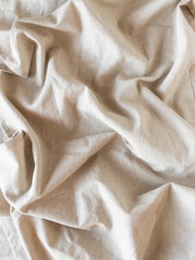 Natural textile linen with folds background. Top view