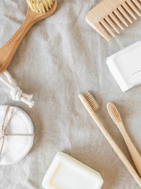 Zero waste care for women's skin. Soap, dry shampoo, cotton buds, toothbrushes, cobs on natural textile background. top view. Copy space