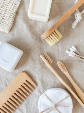 Zero waste care for women's skin. Soap, dry shampoo, cotton buds, toothbrushes, cobs on natural textile background. top view. Copy space
