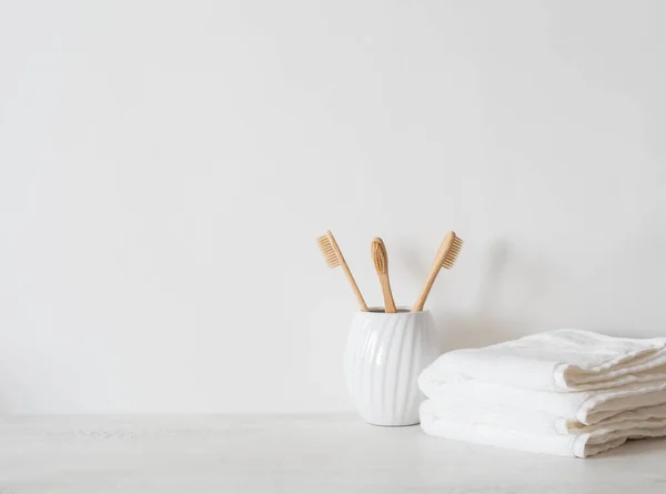 Minimal Bath Background Bamboo Toothbrushs Ceramic Glass White Towels White — Photo