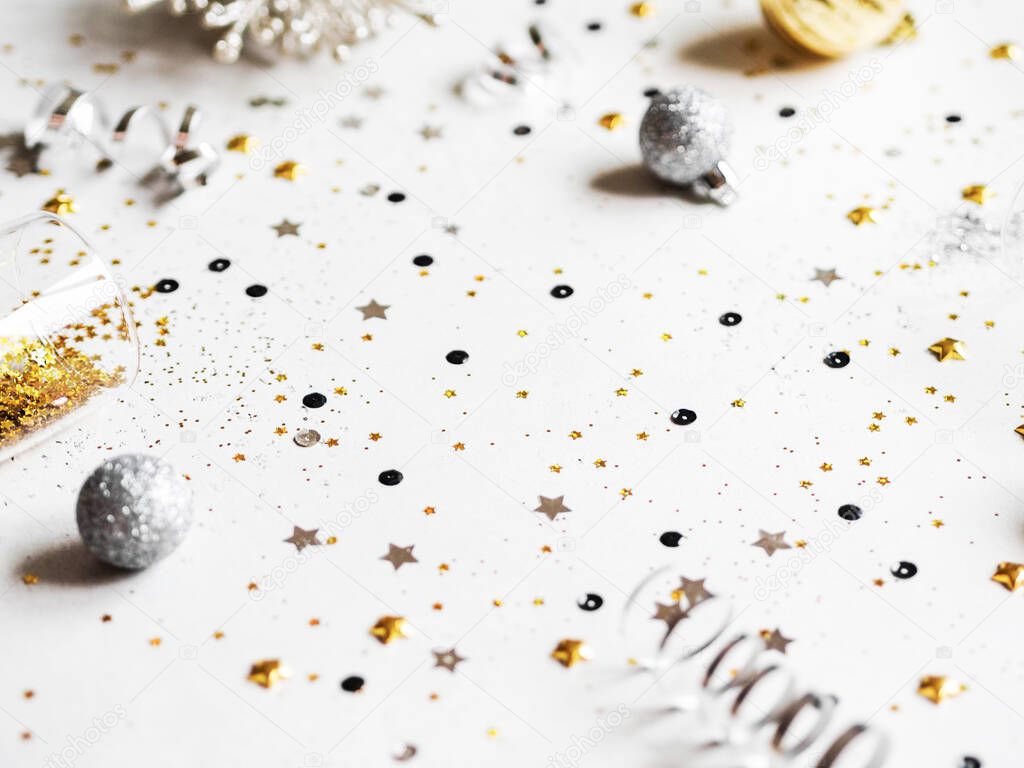 Flat lay of Christmas or New Year, gold and silver party season decorations on white background. Holiday and invitation background. Christmas or new year wish layout. Top view