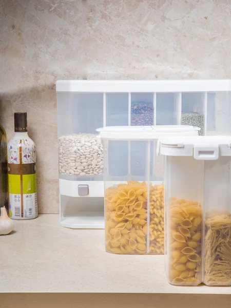 A large selection of bulk dry foods in clever dispensers and a weighing scale at an upscale grocery store
