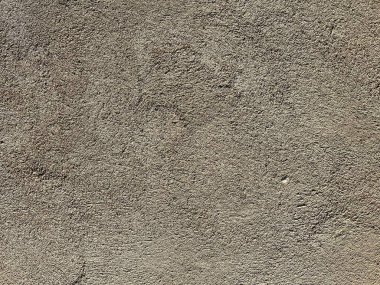 Kaba, desenli beton duvar, doğal kusurlar ve değişik gri tonlarda. Arkaplan, inşaat veya mimari temalar için ideal.