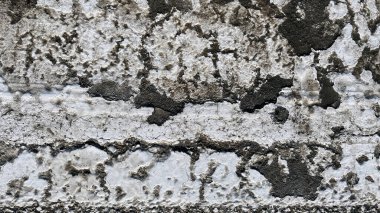 Yıpranmış duvar yüzeyi, soyulmuş boya katmanları, açıkta kalmış pürüzlü yamalar ve çatlak yatay bantlar, sıkıntılı, doğal bir soyut doku yaratıyor..