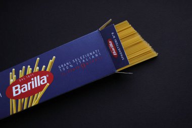 Barilla Spaghettoni makarnası koyu arkaplandaki açık markalı bir paketten kısmen alınmış. İtalyan gıda ürünleri fotokopi alanı ile hala hayat.