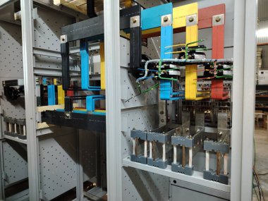 Bir imalat ortamında ağır iş elektrikli büstiyer ve akım algılama ekipmanları montajı.