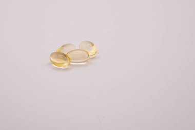 Beyaz bir zemin üzerinde E vitamini tabletlerinin yakın plan fotoğrafı, sağlık, beslenme, sağlık, takviye ve sağlık kavramlarını temsil ediyor.