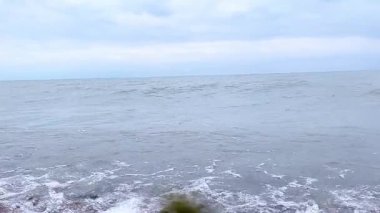 Chicago, Illinois 'deki Michigan Gölü' nün kumlu kıyısına yaklaşan ve çarpan bir dalganın yüksek kaliteli yavaş çekim görüntüleri. Video, suyun detaylı yapısını yakalıyor, beyaz köpük. Sinema sahneleri, arka planlar, meditasyon için. 4K.