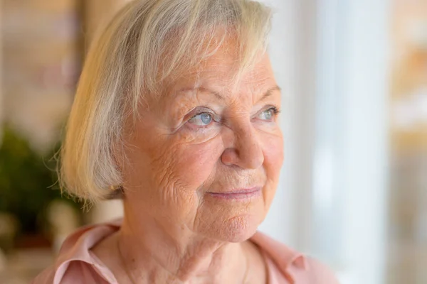Lonely Elderly Woman Standing Reminiscing She Watches Window Home Close — Stock Photo, Image
