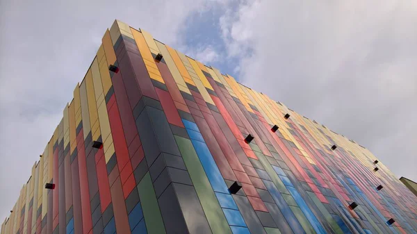 Canlı modern tasarım. Bu eşsiz bina parlak renkler ve göz alıcı bir görünüme sahip. Şehir caddesinde duruyor, yaratıcı mimari ve şehir tarzı sergileniyor..