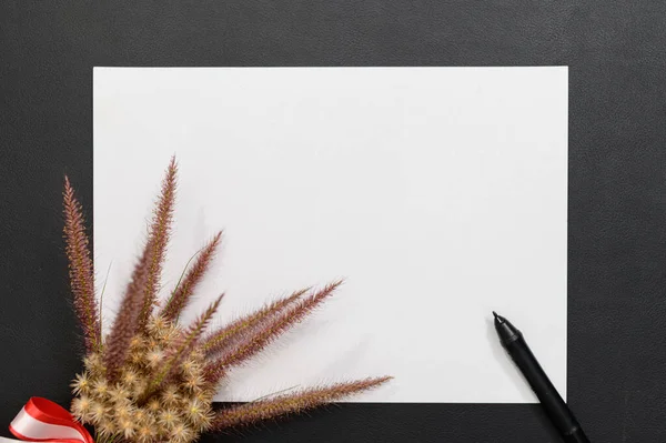 Blank paper and pen on the desk top view