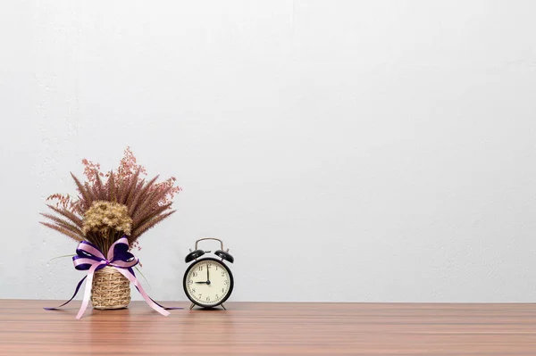 Clocks and flower vases are at your desk.