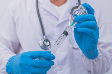 Doktor mikropları önlemek için aşı kullanıyor..
