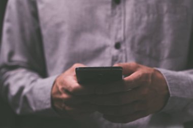 İnsanlar koyu tonlu akıllı telefonlar kullanıyor..