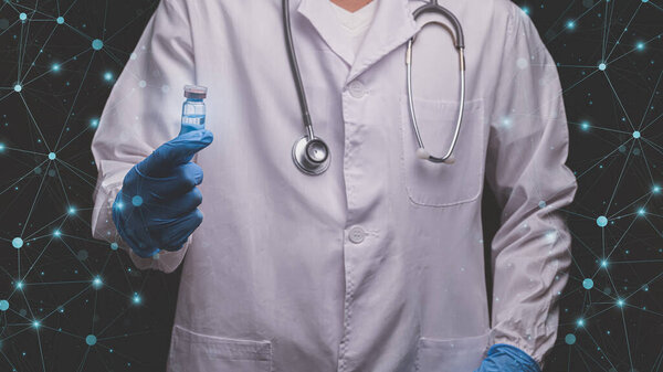 doctor holds a bottle of vaccine medicine