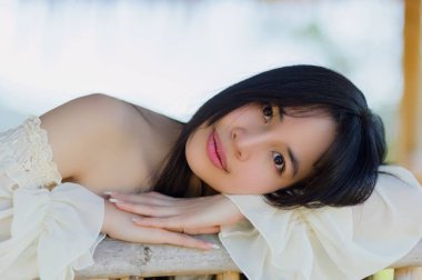 Güzel bir kadının büyüleyici bir portresi baharın canlı çiçeklerinin tadını çıkarıyor. Doğal ortamda dinginliğin ve gençliğin neşesini yakalıyor..