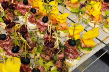 Gourmet appetizers displayed on a platter, featuring a variety of meats, cheeses, and vegetables, highlighting the artistry of catering for events and gatherings