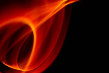 Pürüzsüz turuncu ateş şekilleri derin siyah arkaplanda soyut enerji hareketi oluşturur.