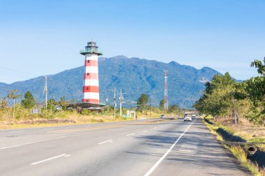 Panama Boquete March 3, the lighthouse that signals the entrance to the residential and commercial area of the same name to the south of the town and the Baru volcano in the background. Shoot on March 3, 2021 clipart