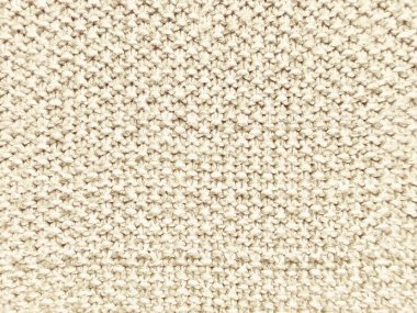 kremsi bej örgü yün desenli makro yakın çekim, nötr duvar kağıdı arkaplanı ya da tekstil tasarım afişi için sıcak ve zarif çağrıştırıyor..