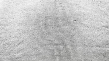 İnce dalgalarla dalgalanmış kum dokusu. Yumuşak gölgeler. Minimalist monokrom bileşimindeki küçük siyah leke.