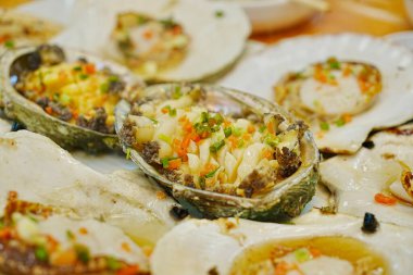 Sos ve otlarla servis edilen taze istiridyeler.