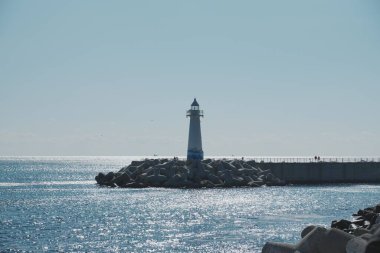 Lighthouse standing on rocky coastline